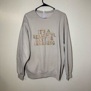 Women’s Cream Graphic “It’s A Beautiful Day For Learning” Crew Neck Sweater